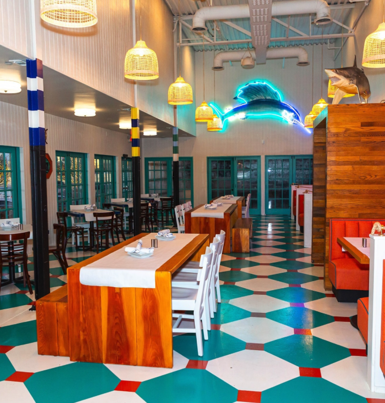 Pesca reutilized the neon swordfish from Amberjax, which was formerly in the Trinity Groves space. (Courtesy of Pesca via Instagram)